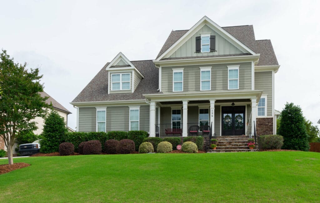 Two-story home exterior after painting by Oak City Coatings in the Triangle