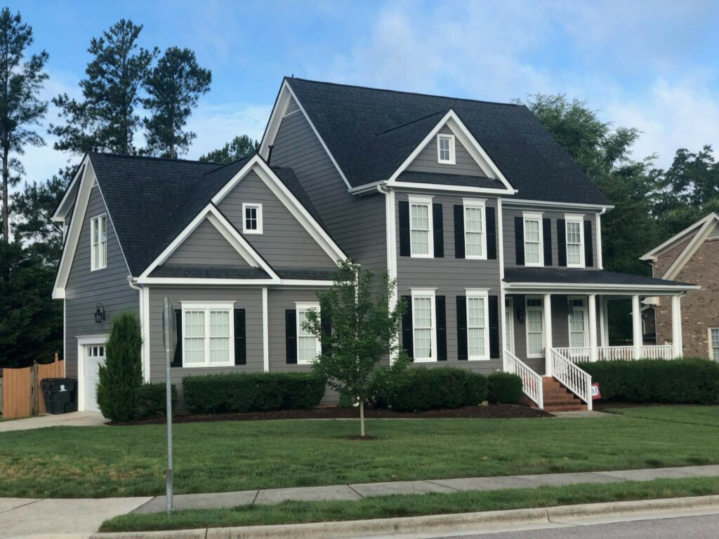 The same home after an Oak City Coatings exterior repaint in Sherwin-Williams Gauntlet Gray with white trim
