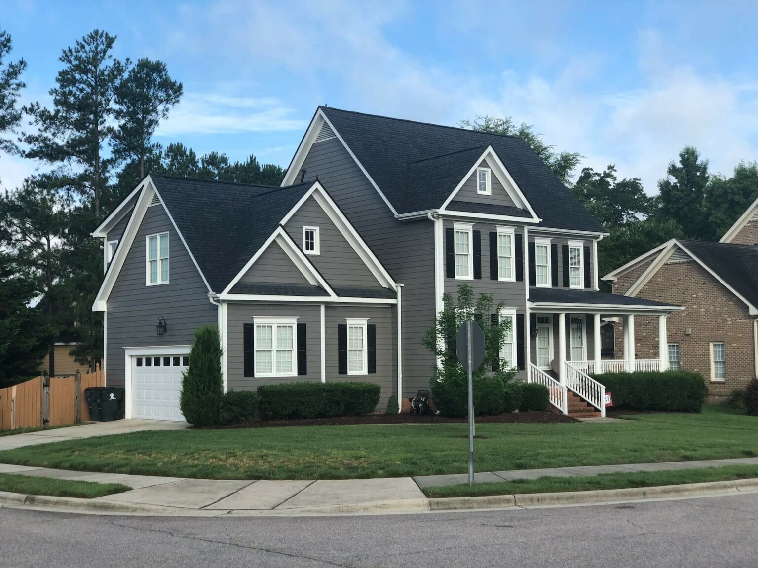 The same home after an Oak City Coatings exterior repaint in Sherwin-Williams Gauntlet Gray with white trim