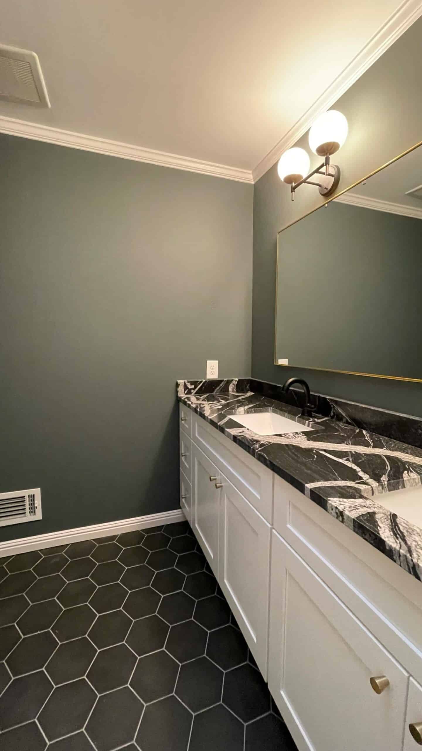 dark green paint in bathroom with dark counter