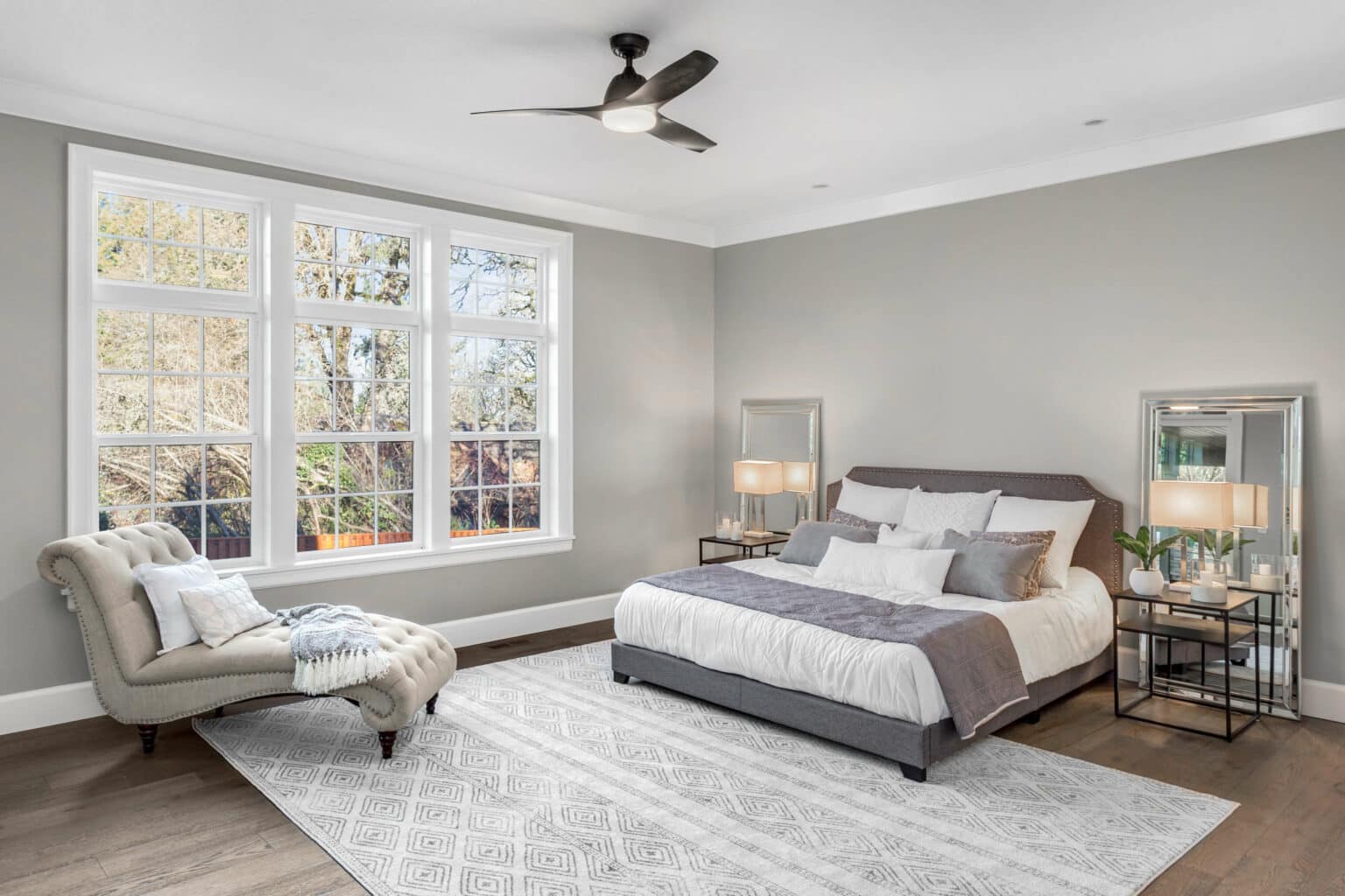 Bedroom with fresh light gray walls after an interior repaint by Oak City Coatings in Raleigh, NC