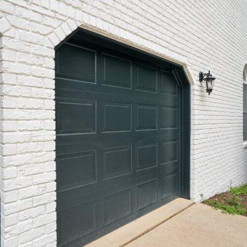 white romabio painted brick above garage