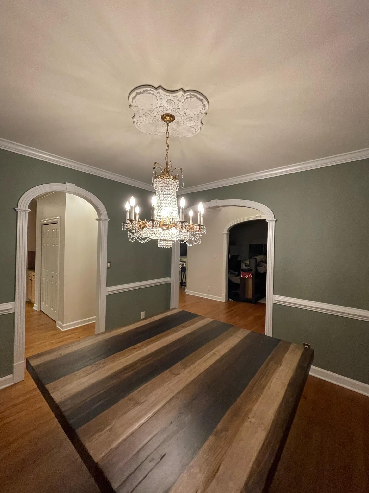 green painted dining room interior painting services by Oak City Coatings