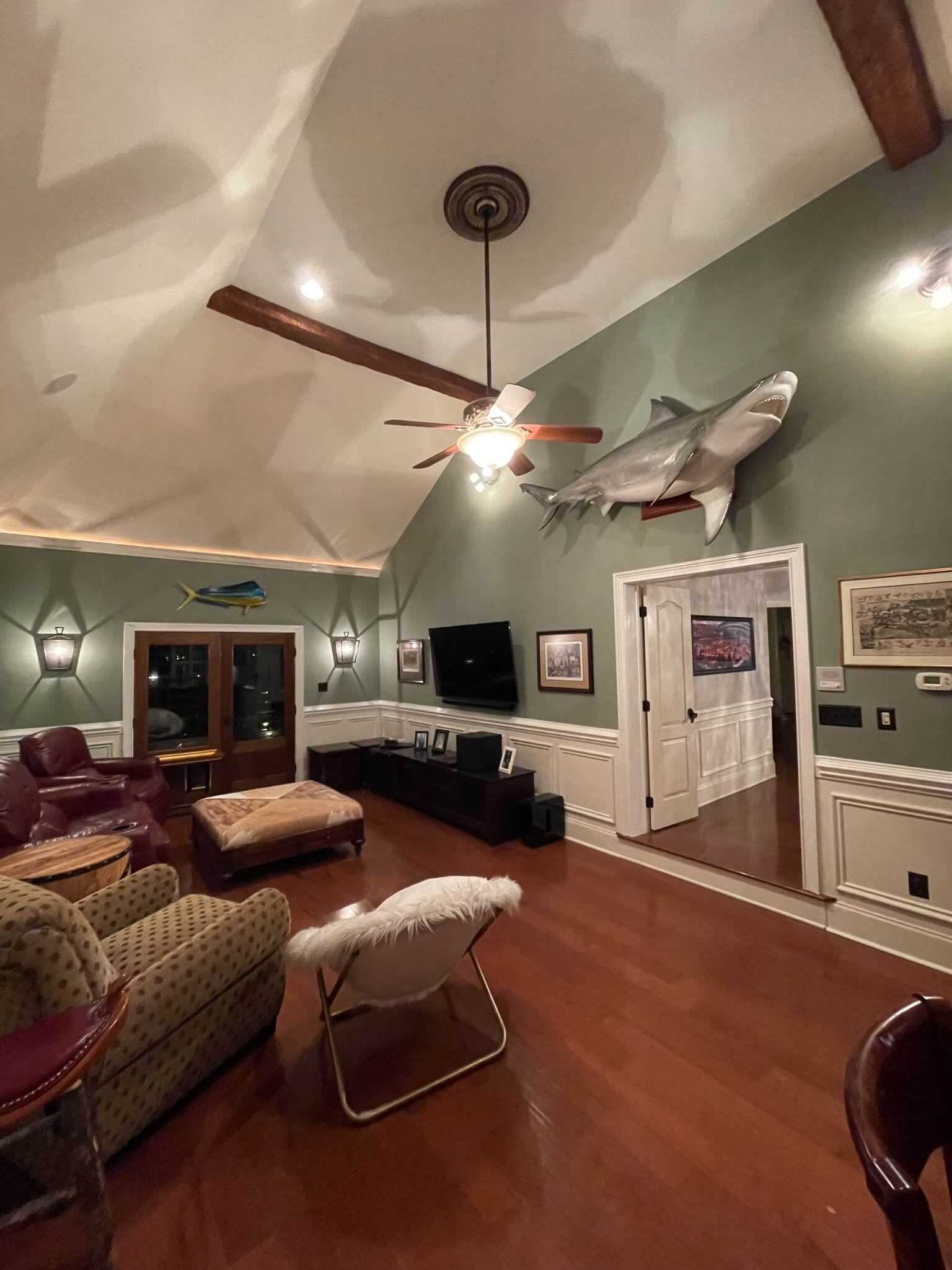 residential painting by Oak City Coatings in living room with couch and paintings