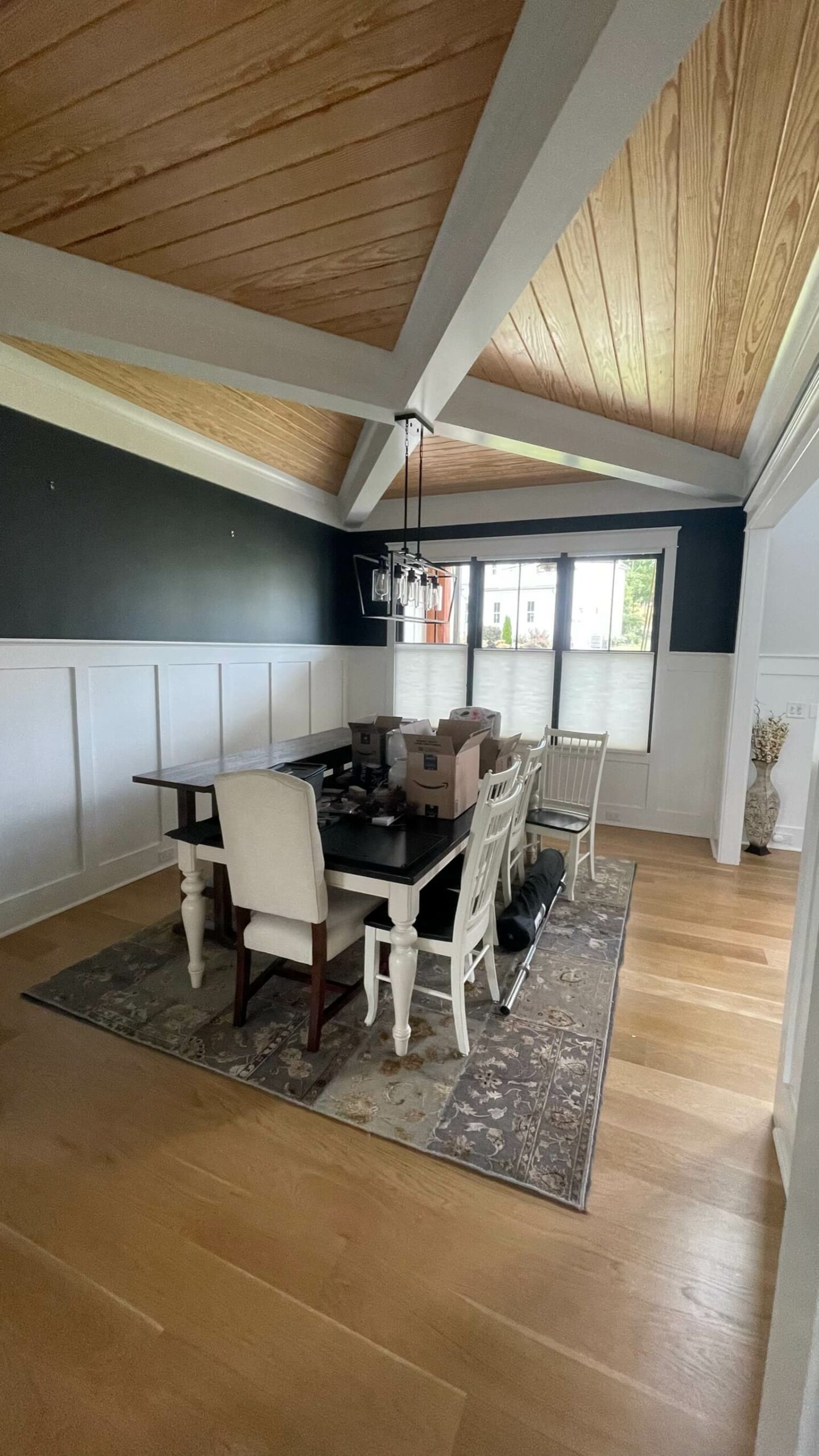 painted dining room with dark paint, accented with wood