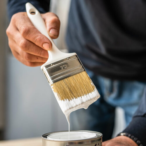 painter cleaning a paint brush