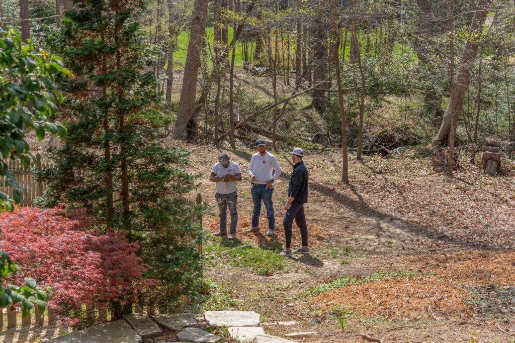 Oak City Coatings answering questions during paint estimate standing outside.