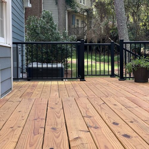 getting ready to restain a deck in Raleigh home, stained and prepped by Oak City Coatings.