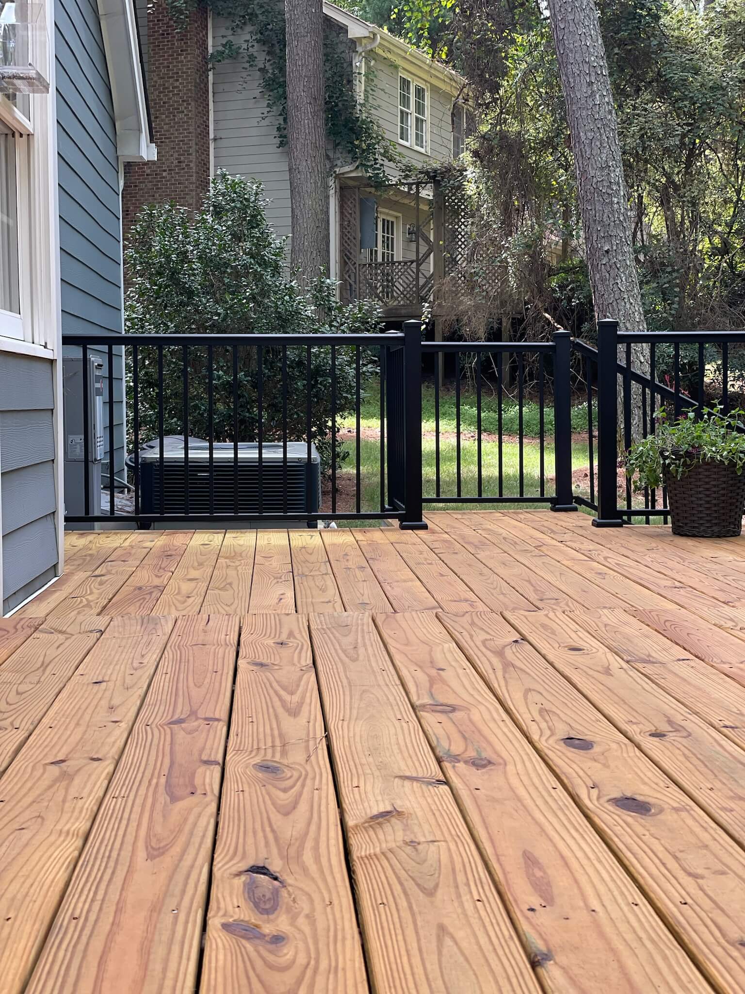 getting ready to restain a deck in Raleigh home, stained and prepped by Oak City Coatings.