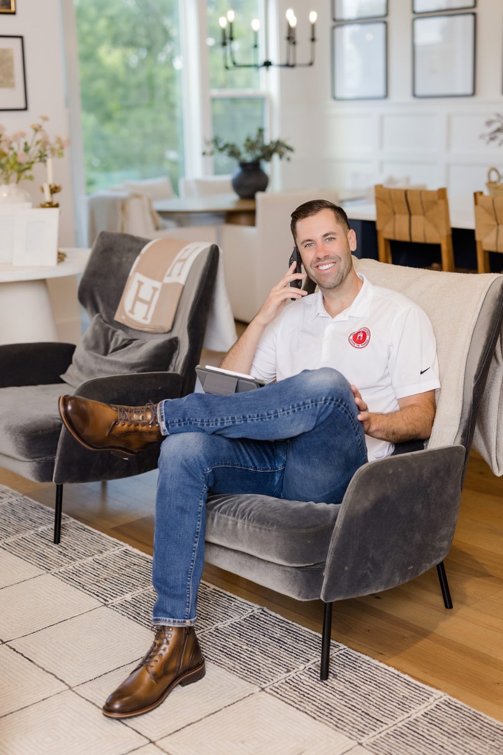 Nick O'Keefe, owner of Raleigh paint company, Oak City Coatings sitting in house on phone.