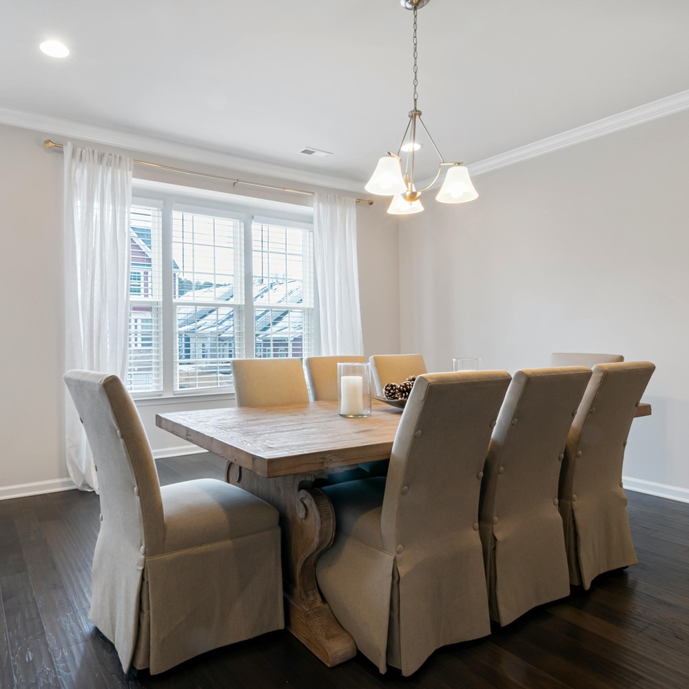 greige accent wall in dining room with table in Cary, NC