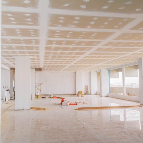 a commercial room with white walls and white pillars