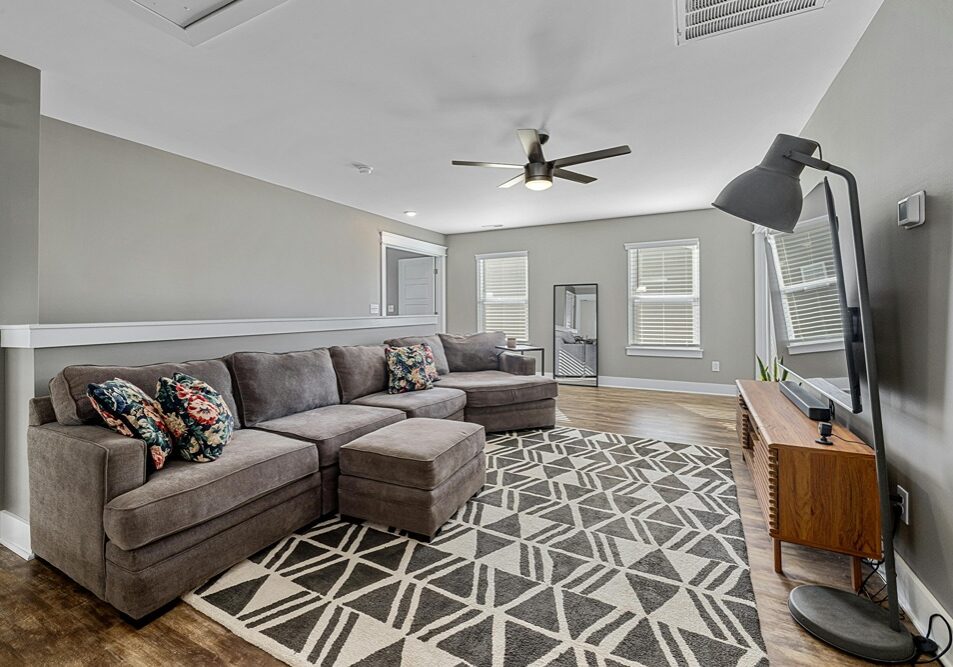 a play room with a large couch and durable paint for high traffic areas