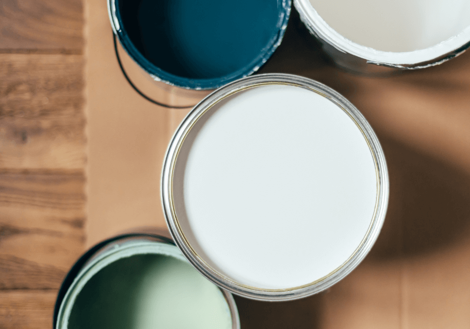 Homeowner getting ready to dispose of paint cans after painting project in Raleigh.